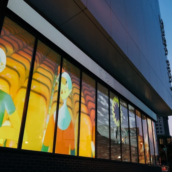 Moving-image displays in the windows of the SNF Parkway Theatre.
