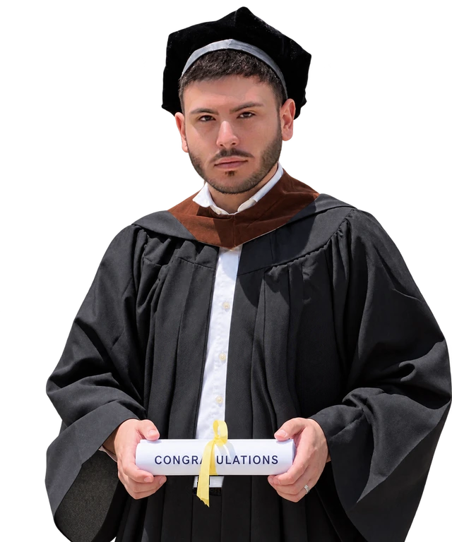 Alex in his MICA graduation cap and gown, holding a diploma tied with a yellow ribbon.