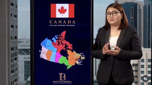 Presenter beside a Canada skilled worker programme display in the Bayat office.