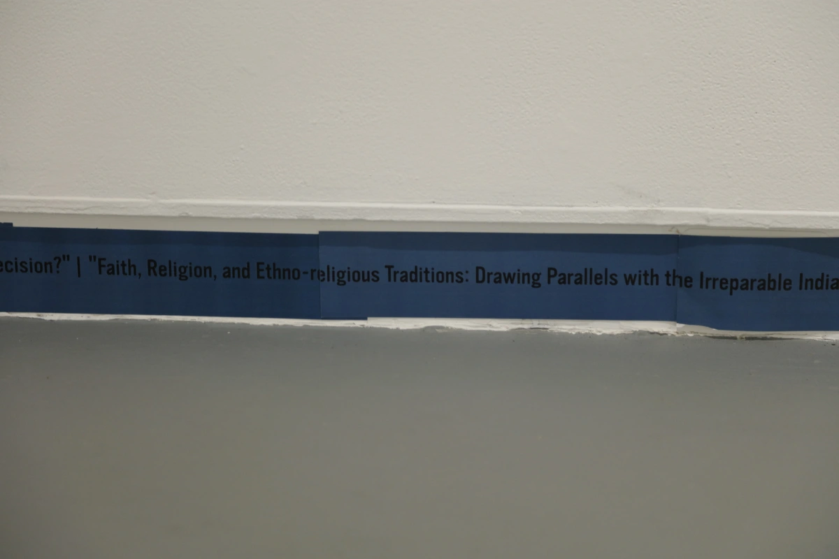 Original blue text band installed along the gallery base